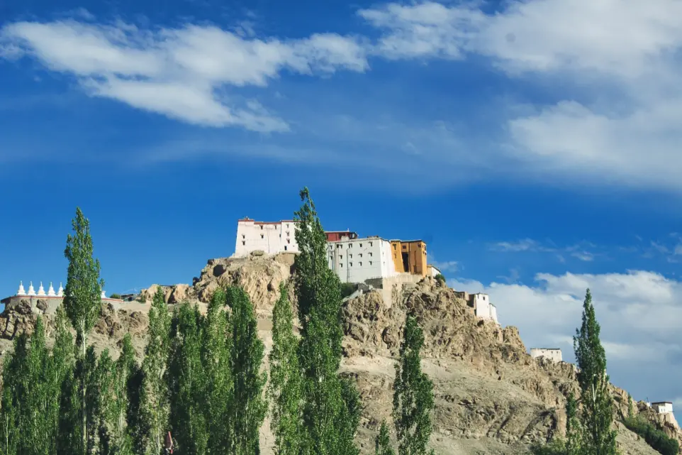 brown concrete building on top of mountain under blue sky during daytime